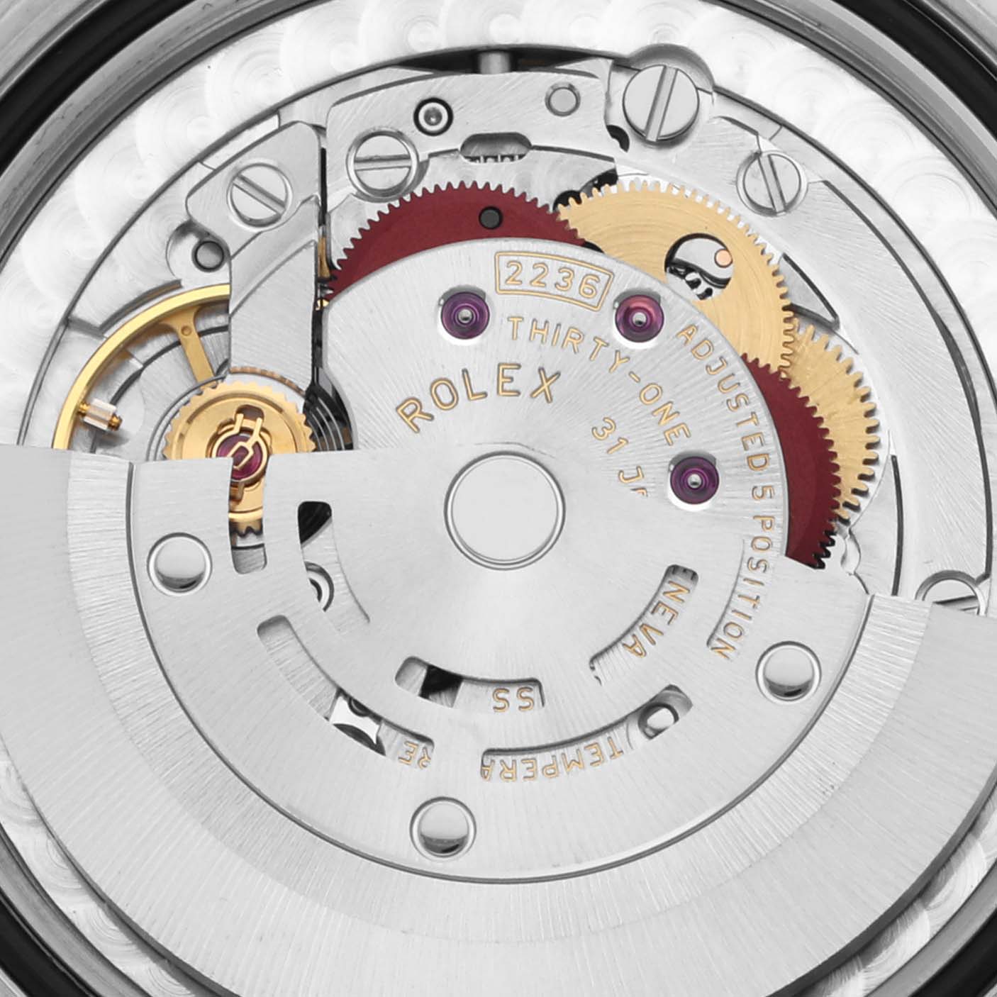 The image shows the intricate movement of a Rolex Mid-Size 278271 Women's Steel and Gold (two tone) Pink Dial 278271 Women's Steel and Gold (two tone) Pink Dial model, highlighting gears and the rotor from an overhead angle.