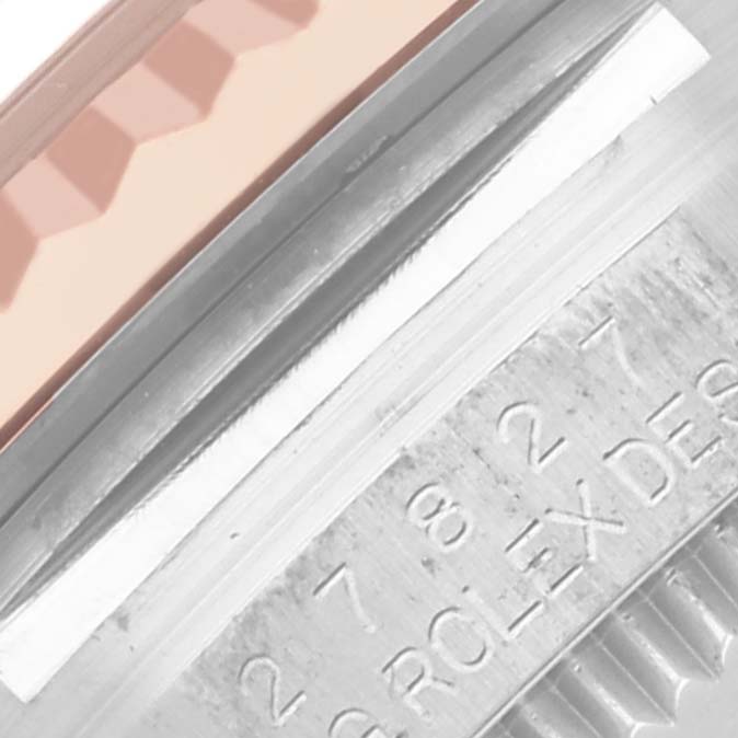 The image shows a close-up of a Rolex Mid-Size 278271 Women's Steel and Gold (two tone) Pink Dial 278271 Women's Steel and Gold (two tone) Pink Dial watch with part of the bezel and engraved serial numbers visible.