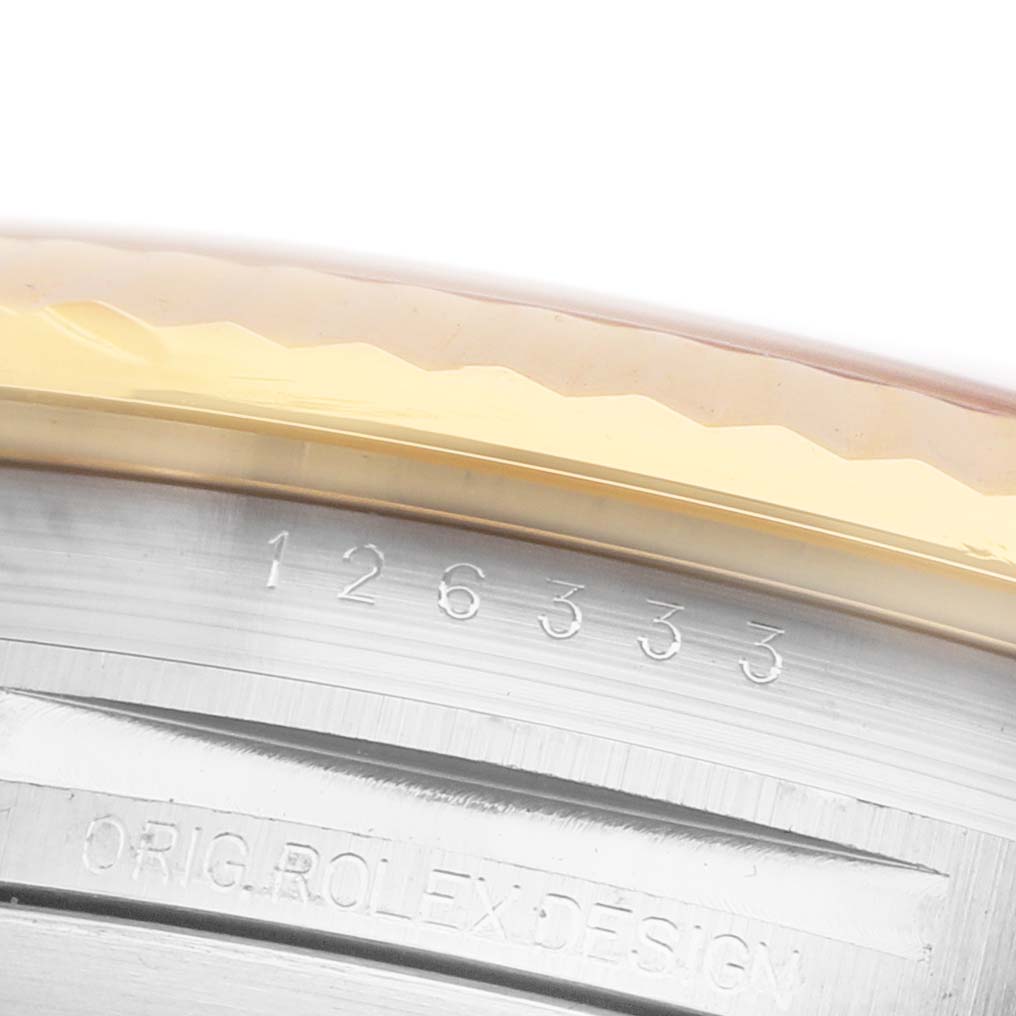The image shows a close-up of the inner bezel of a Rolex Datejust 41 M126333-0011 Men's Steel and Gold (two tone) Champagne Dial watch, displaying engraved markings.