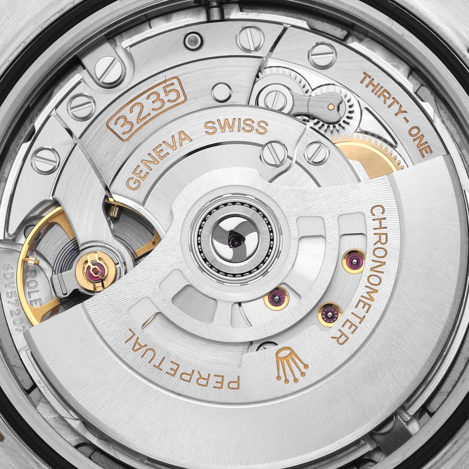 The image shows a close-up of the movement of a Rolex Datejust 41 126333 Men's Steel and Gold (two tone) Grey Dial 126333 Men's Steel and Gold (two tone) Grey Dial, highlighting the rotor and intricate components.