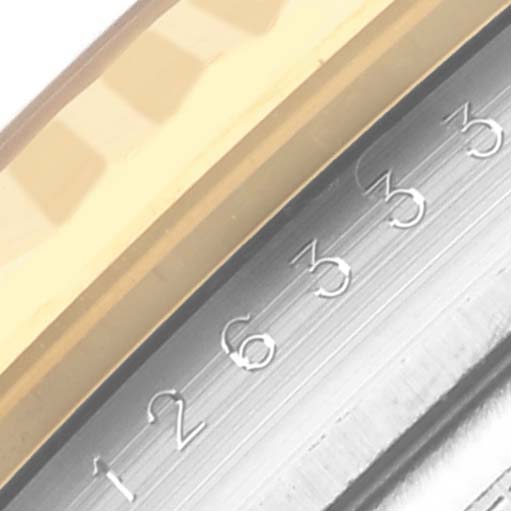 The image shows a close-up of the gold bezel and numeric markers on the Rolex Datejust 41 126333 Men's Steel and Gold (two tone) Grey Dial 126333 Men's Steel and Gold (two tone) Grey Dial's fluted edge.