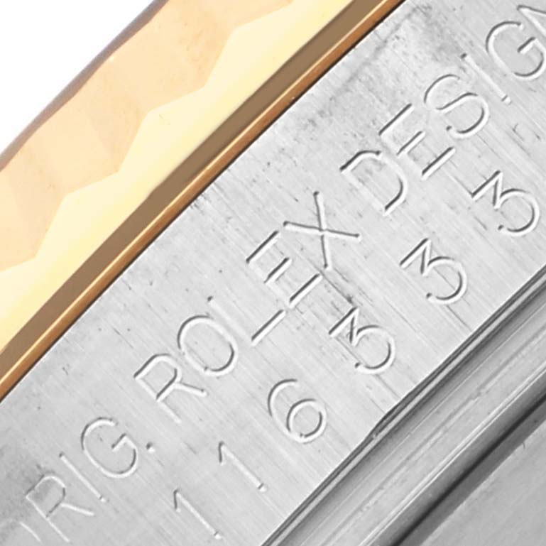 The image shows a close-up of the Rolex Datejust 41 116333 Men's Steel and Gold (two tone) Black Dial 116333 Men's Steel and Gold (two tone) Black Dial's bezel and part of the engraved inner ring.