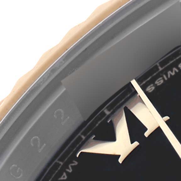 The image shows an angled close-up of the Rolex Datejust 41 116333 Men's Steel and Gold (two tone) Black Dial 116333 Men's Steel and Gold (two tone) Black Dial bezel, dial, and Roman numeral hour marker.