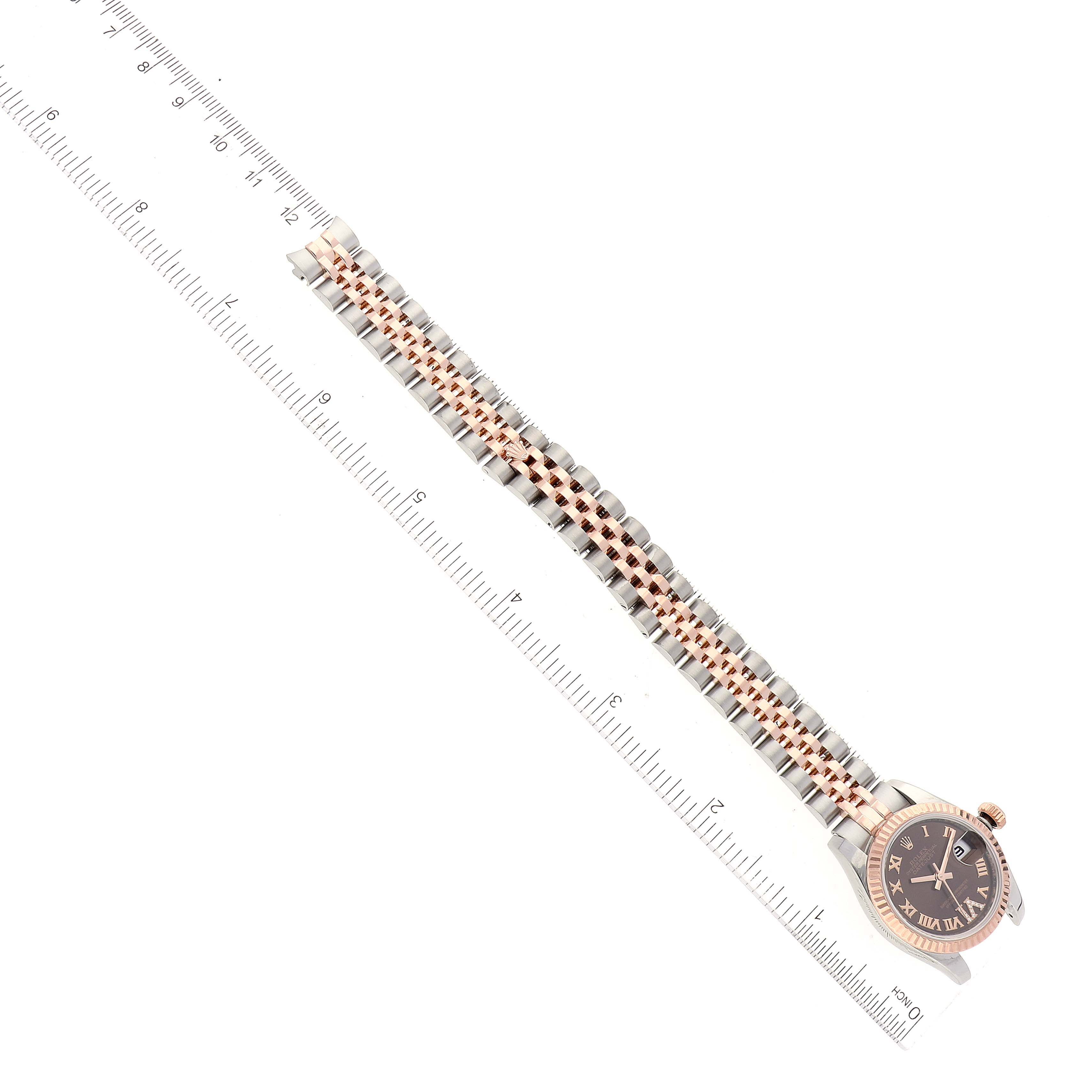 The image shows a side view of a Rolex Datejust 179171 Women's Steel and Gold (two tone) Brown Dial 179171 Women's Steel and Gold (two tone) Brown Dial watch, emphasizing its band and dial, placed beside a ruler for scale.