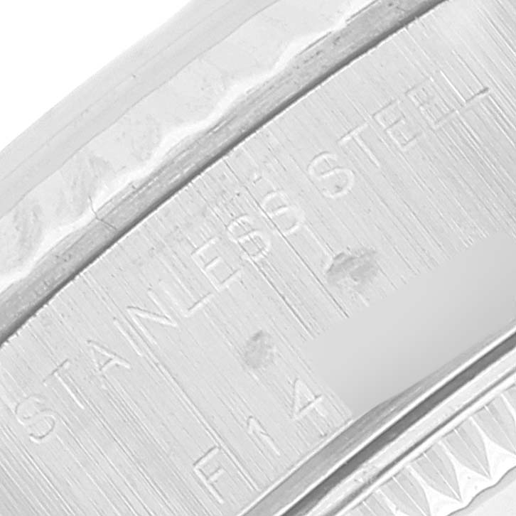 This close-up image of a Rolex Datejust 79174 Women's Steel and Gold (two tone) Mother of Pearl Dial 79174 Women's Steel and Gold (two tone) Mother of Pearl Dial model shows the side engraving on the stainless steel case.