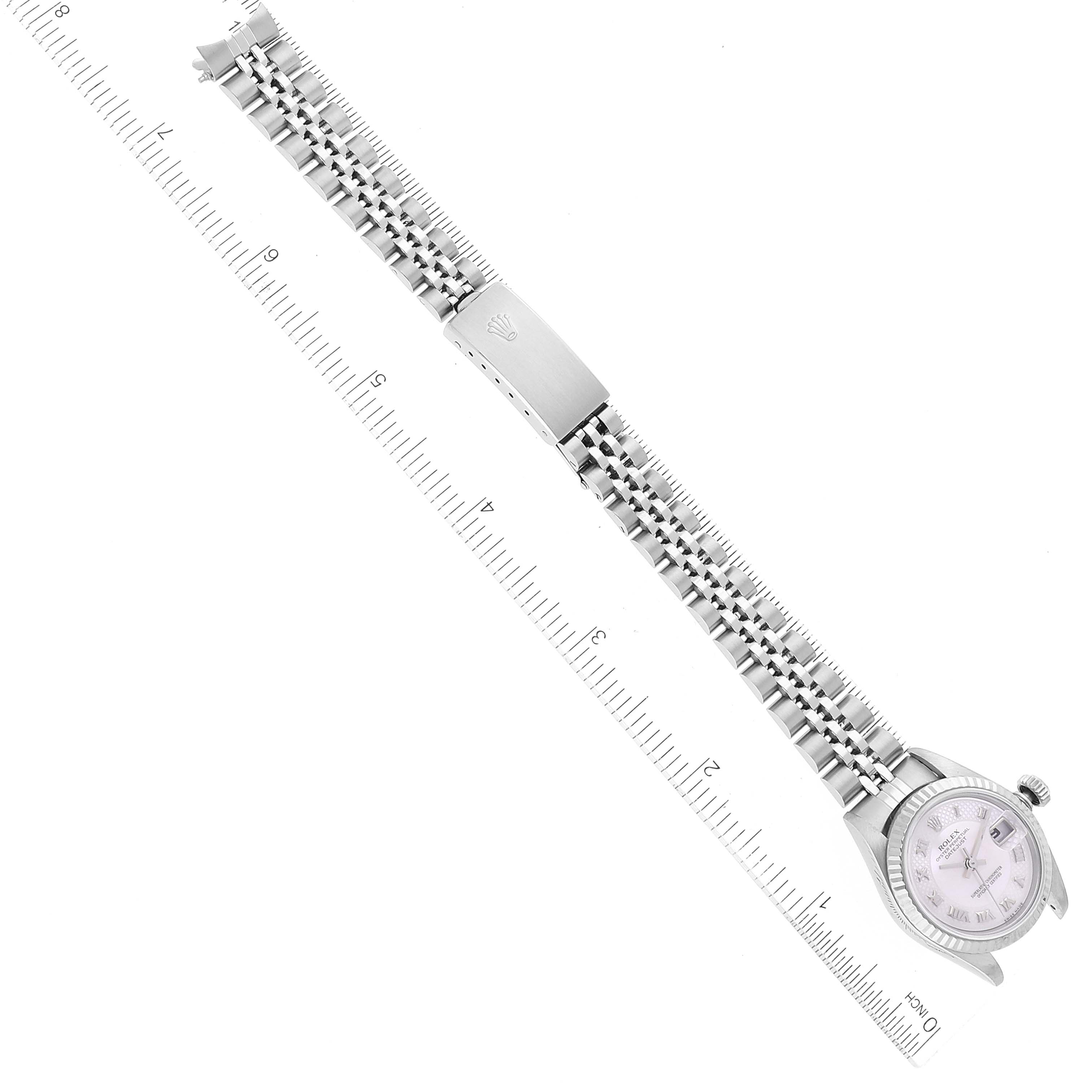 The image shows an overhead view of a Rolex Datejust 79174 Women's Steel and Gold (two tone) Mother of Pearl Dial 79174 Women's Steel and Gold (two tone) Mother of Pearl Dial watch, displaying the face, bracelet, and clasp, positioned with rulers for scale.