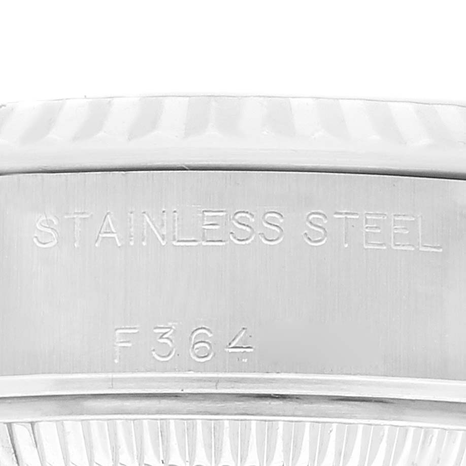 The image shows a close-up view of the stainless steel back of a Rolex Datejust 79174 Women's Stainless Steel Mother of Pearl Dial 79174 Women's Stainless Steel Mother of Pearl Dial watch, featuring engravings.