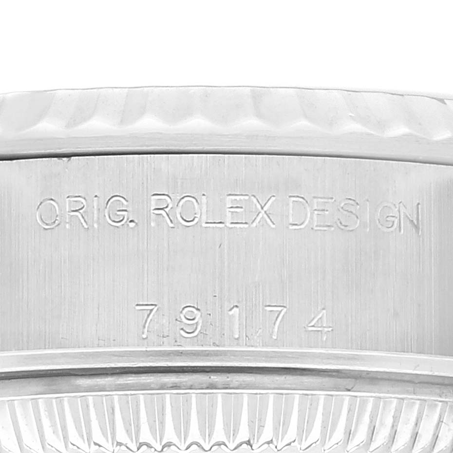 This close-up image shows the side of the Rolex Datejust 79174 Women's Stainless Steel Mother of Pearl Dial 79174 Women's Stainless Steel Mother of Pearl Dial watch case, featuring the engravings and partial bezel.