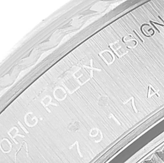 This close-up image shows the engraved text on the side of a Rolex Datejust 79174 Women's Stainless Steel Mother of Pearl Dial 79174 Women's Stainless Steel Mother of Pearl Dial watch case.