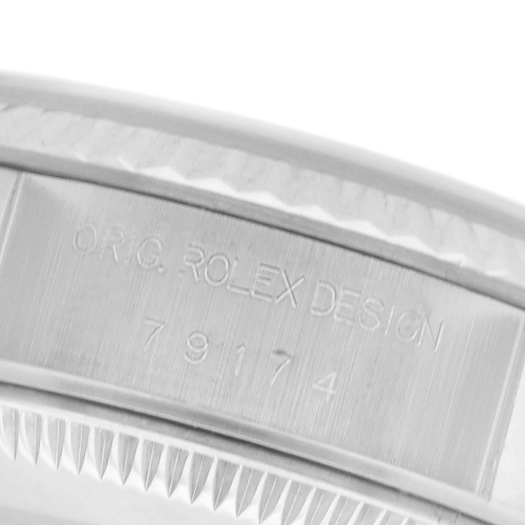 The image shows a close-up of the bezel and case of a Rolex Datejust 79174 Women's Stainless Steel Silver Dial 79174 Women's Stainless Steel Silver Dial, highlighting the model number engraving.