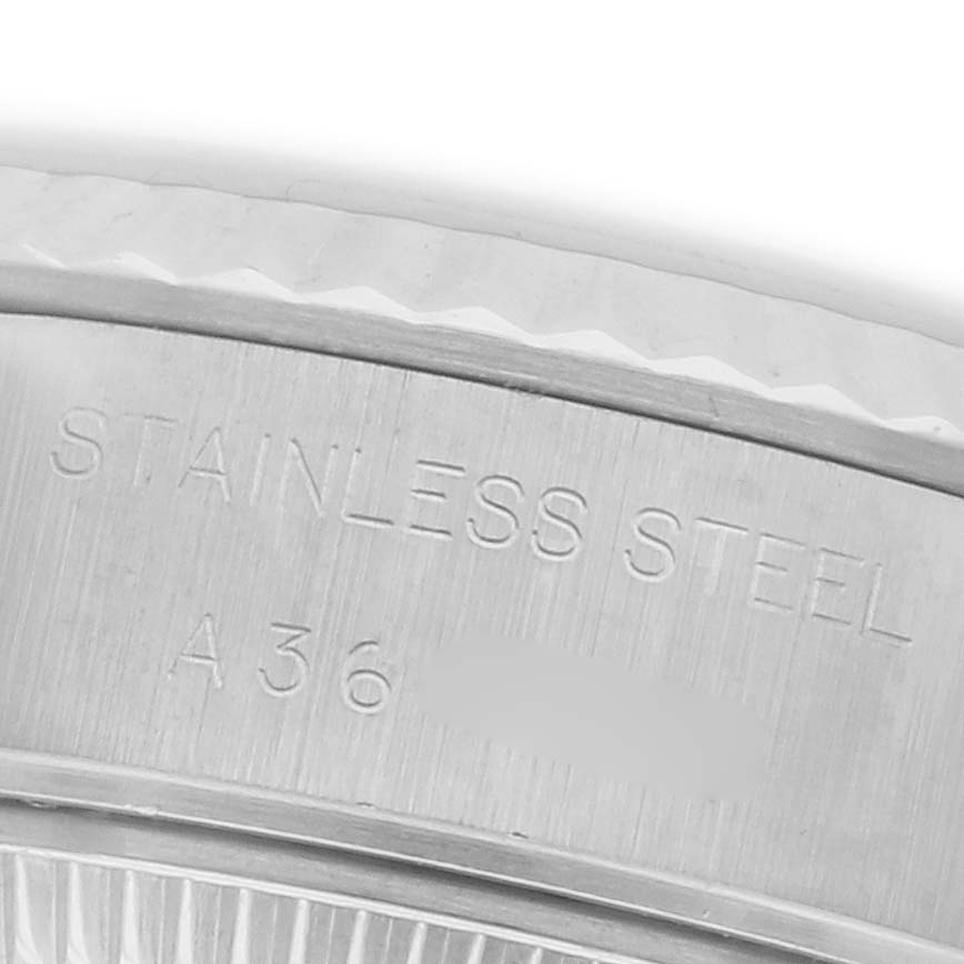 The image shows a close-up of the stainless steel case with engravings on a Rolex Datejust 79174 Women's Stainless Steel Silver Dial 79174 Women's Stainless Steel Silver Dial.