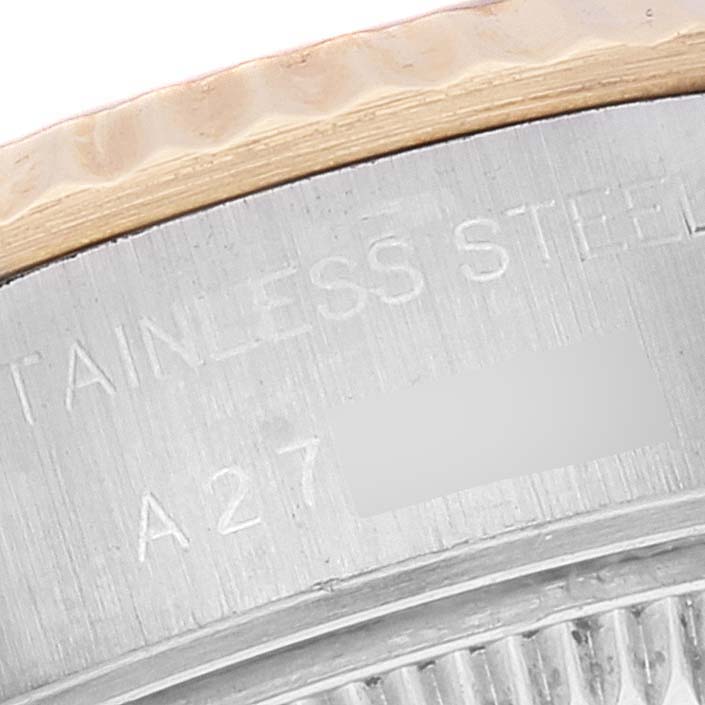 The image shows a close-up of the side engraving on a Rolex Datejust A278921 Women's Steel and Gold (two tone) Champagne Dial A278921 Women's Steel and Gold (two tone) Champagne Dial watch, highlighting "STAINLESS STEEL" and part of the serial number.