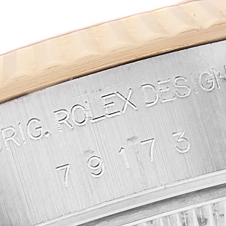 Close-up image of the side engraving and fluted bezel of a Rolex Datejust A278921 Women's Steel and Gold (two tone) Champagne Dial A278921 Women's Steel and Gold (two tone) Champagne Dial watch.