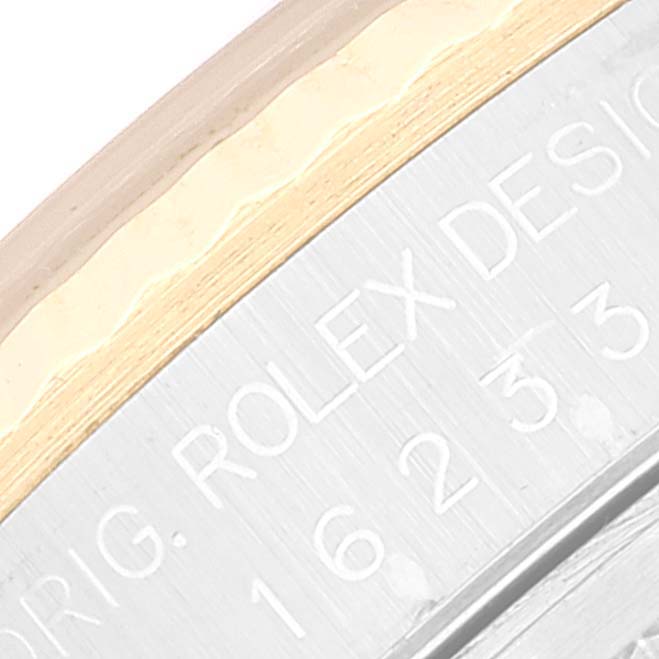 This close-up image shows the engraving and part of the bezel of the Rolex Datejust 16233 Men's Steel and Gold (two tone) Black Dial 16233 Men's Steel and Gold (two tone) Black Dial watch.