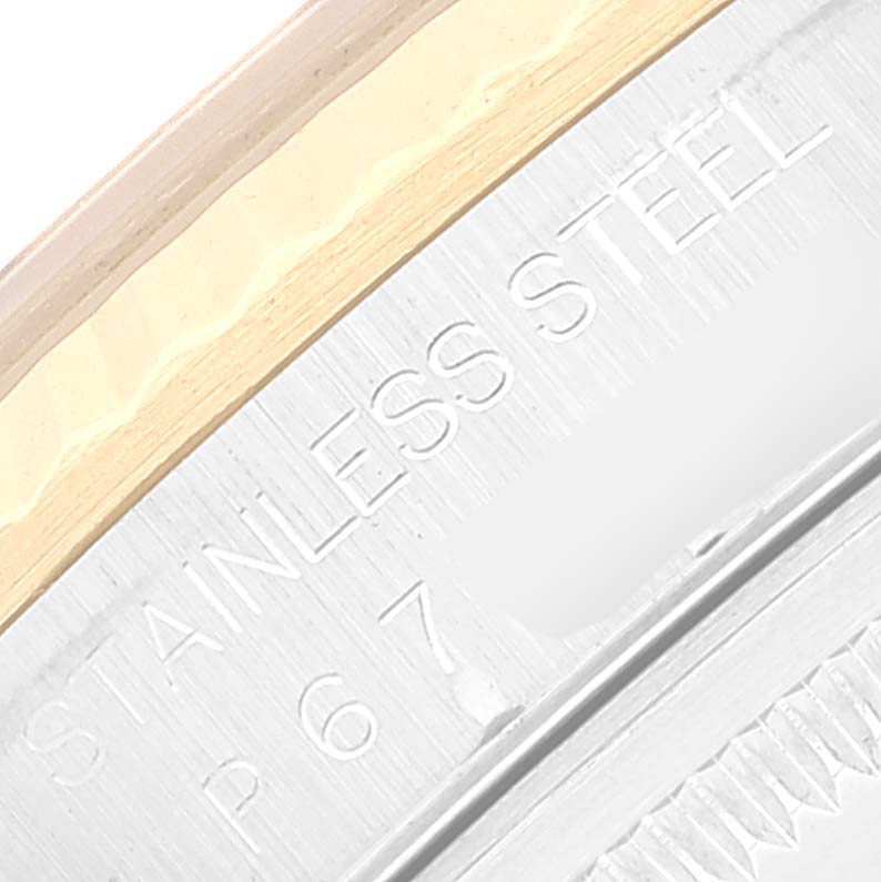 This close-up image shows part of the caseback and bezel of a Rolex Datejust 16233 Men's Steel and Gold (two tone) Black Dial 16233 Men's Steel and Gold (two tone) Black Dial watch, highlighting the "STAINLESS STEEL" engraving.