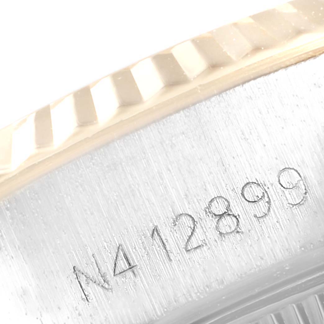 This image shows a close-up of the serial number engraved on the side bezel of a Rolex Datejust 69173 Women
s Stainless Steel Blue Dial 69173 Women
s Stainless Steel Blue Dial watch.