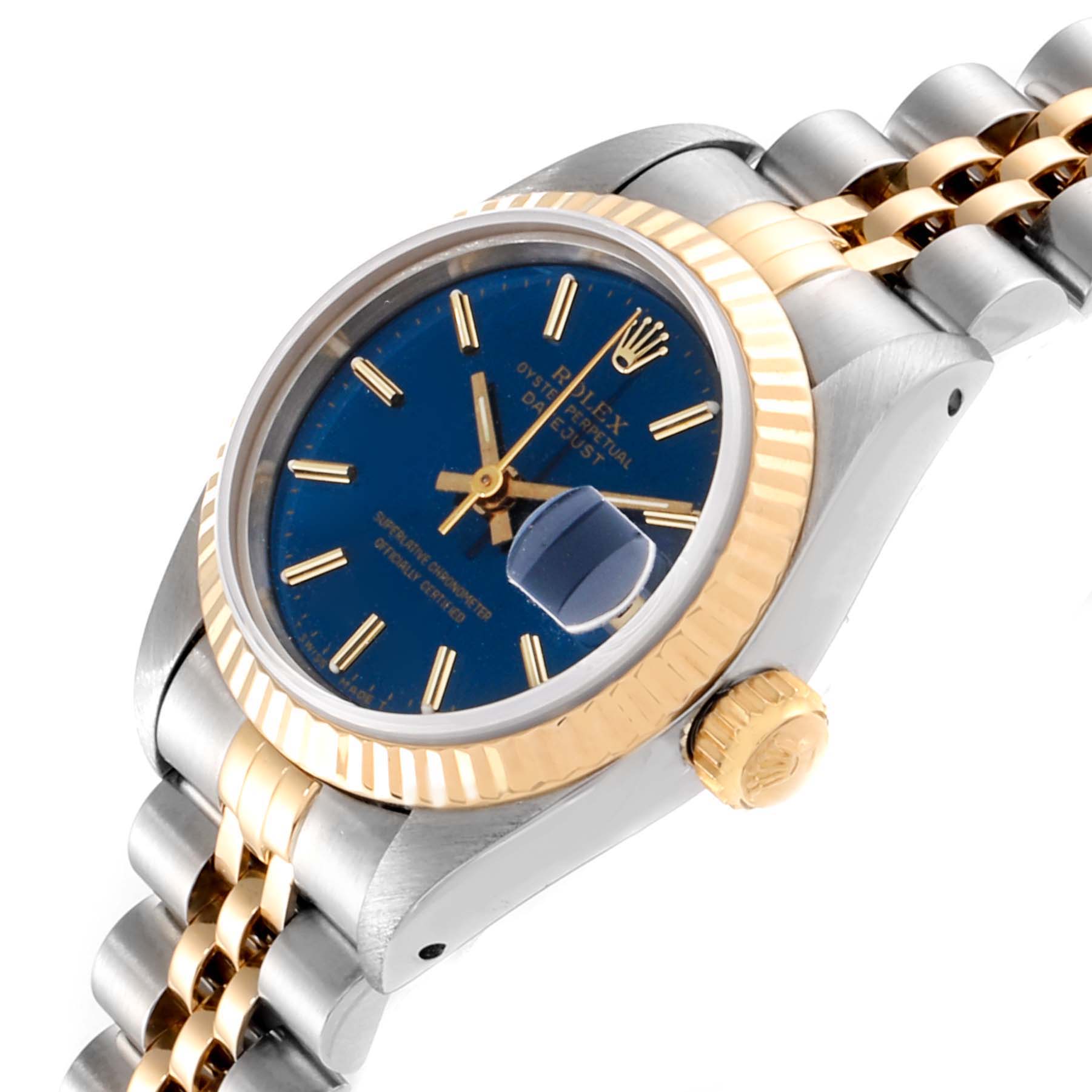 This image shows a Rolex Datejust 69173 Women
s Stainless Steel Blue Dial 69173 Women
s Stainless Steel Blue Dial watch at an oblique angle, featuring the blue dial, gold fluted bezel, and two-tone bracelet.