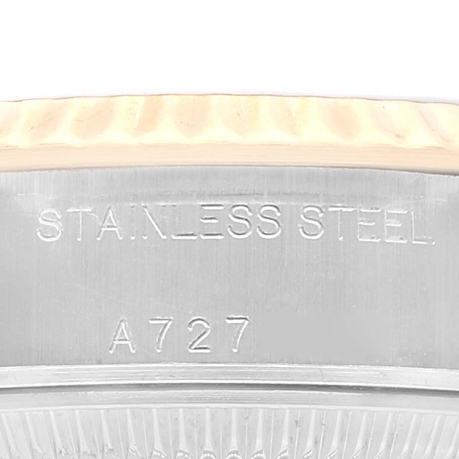 The image shows a close-up of the side of a Rolex Datejust 79173 Women's Steel and Gold (two tone) Champagne Dial 79173 Women's Steel and Gold (two tone) Champagne Dial watch, focusing on the stainless steel marking and part of the case.