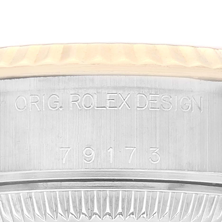 This close-up image shows the model number and "ORIG. ROLEX DESIGN" engraving on the side of a Rolex Datejust 79173 Women's Steel and Gold (two tone) Champagne Dial 79173 Women's Steel and Gold (two tone) Champagne Dial watch case.