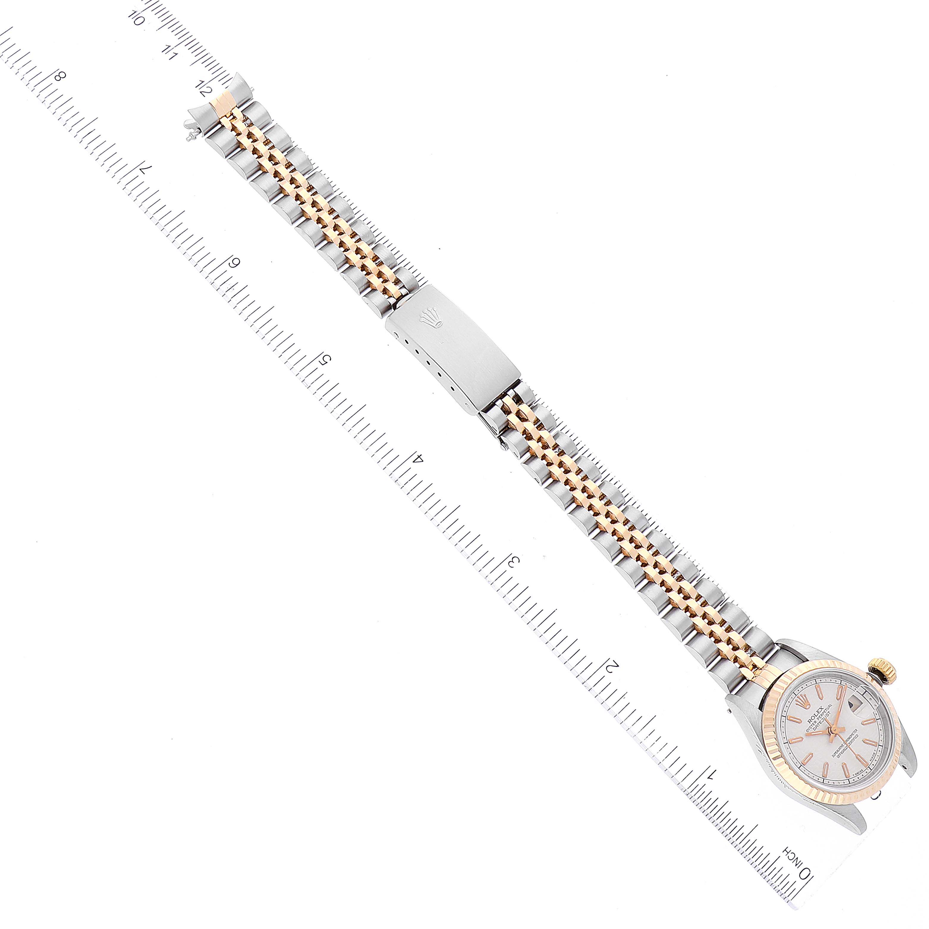 The image shows a top-down view of a Rolex Datejust 69173 Women's Steel and Gold (two tone) Beige Dial 69173 Women's Steel and Gold (two tone) Beige Dial watch, highlighting the face, bezel, and bracelet against a ruler for scale.