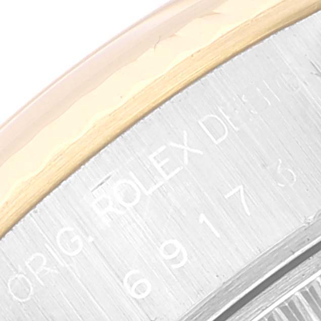 The image shows a close-up of the bezel and engraved details on the side of a Rolex Datejust 69173 Women's Steel and Gold (two tone) Beige Dial 69173 Women's Steel and Gold (two tone) Beige Dial watch.