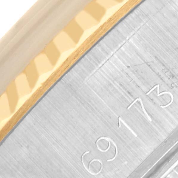 This image focuses on the edge detail of the bezel and case of a Rolex Datejust 69173 Women's Steel and Gold (two tone) White Dial 69173 Women's Steel and Gold (two tone) White Dial, highlighting the serial number and fluted bezel design.