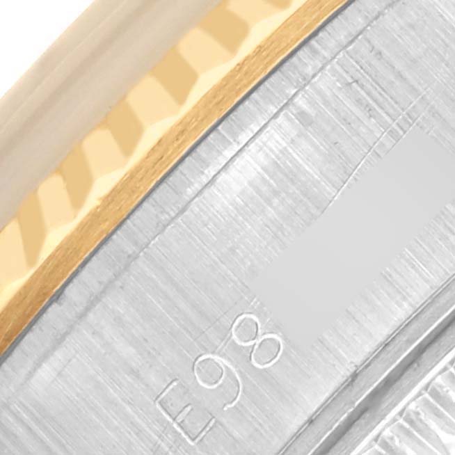 The image shows a close-up of the bezel and engraved serial number of a Rolex Datejust 69173 Women's Steel and Gold (two tone) White Dial 69173 Women's Steel and Gold (two tone) White Dial watch, highlighting the gold and silver elements.