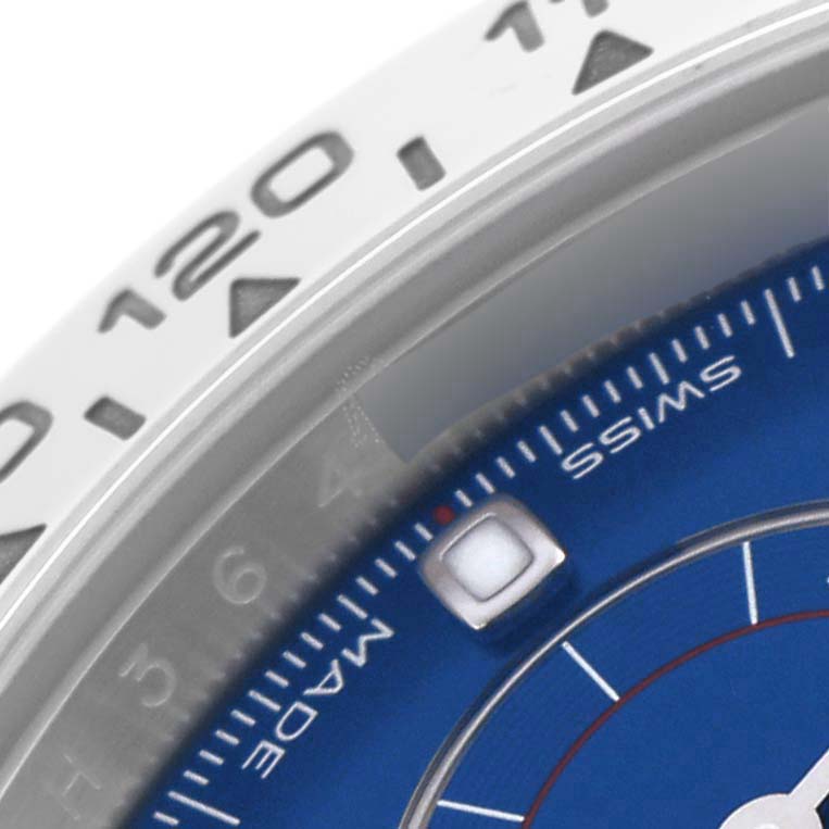 The image shows a close-up of the Rolex Daytona 116509 Men's White Gold Blue Dial 116509 Men's White Gold Blue Dial watch, highlighting part of the bezel and the edge of the blue dial.