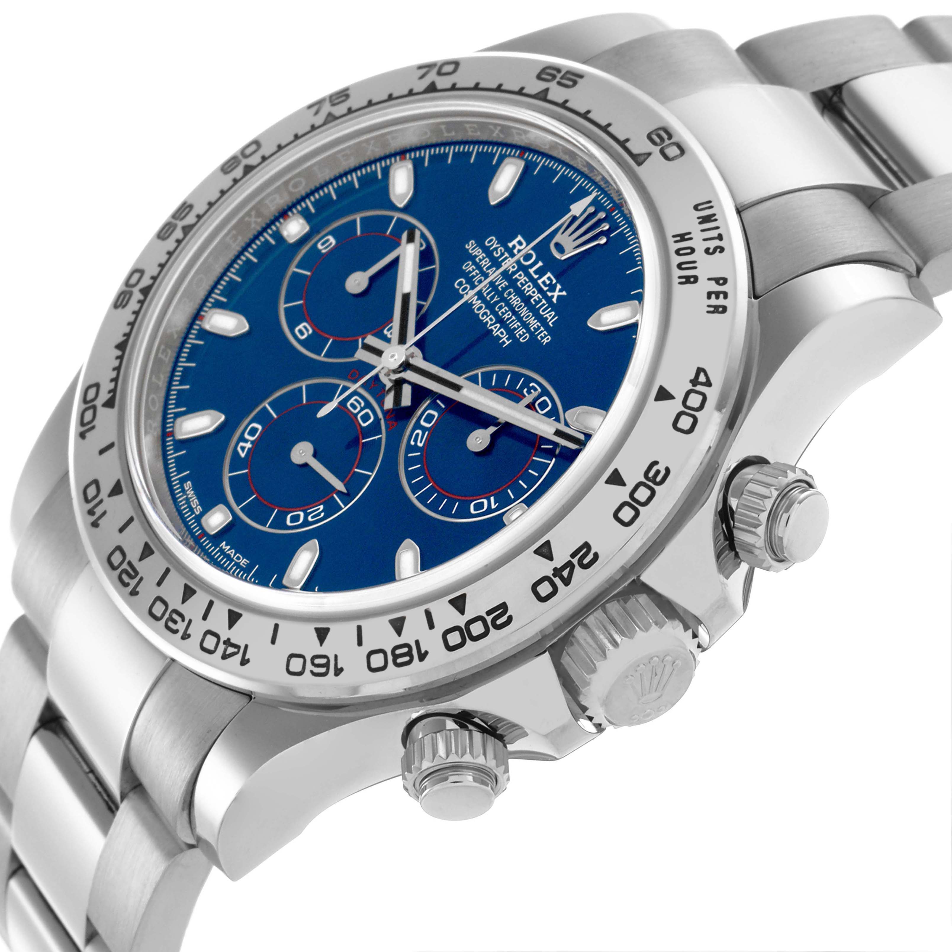 The Rolex Daytona 116509 Men's White Gold Blue Dial 116509 Men's White Gold Blue Dial watch is shown from a slight side angle, highlighting the blue dial, bezel, and chronograph pushers.