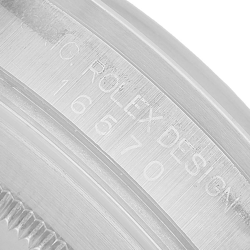 The image shows a close-up of the Rolex Explorer 16570 Men's Stainless Steel White Dial's inner bezel area with engraved details.