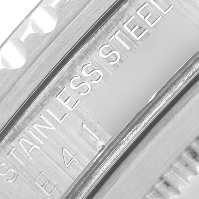 The image shows a close-up of the Rolex GMT-Master 16700 Men's Stainless Steel Black Dial 16700 Men's Stainless Steel Black Dial model's case, highlighting "STAINLESS STEEL" engraving.