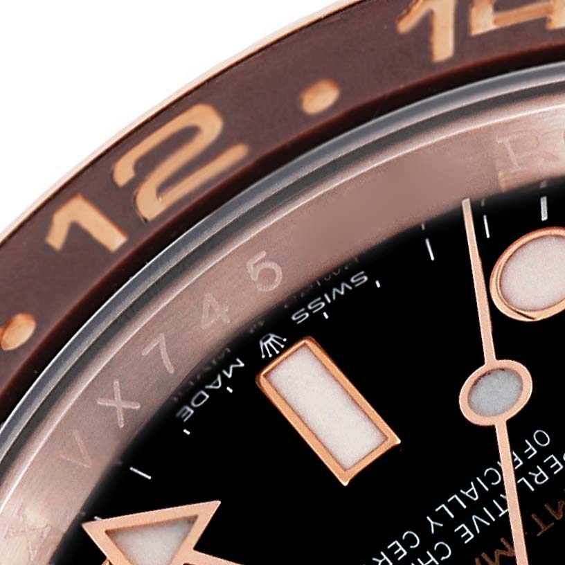 The image shows a close-up of the bezel, part of the dial, and hands of a Rolex GMT-Master 126715CHNR Men
s Rose Gold Black Dial 126715CHNR Men
s Rose Gold Black Dial watch.