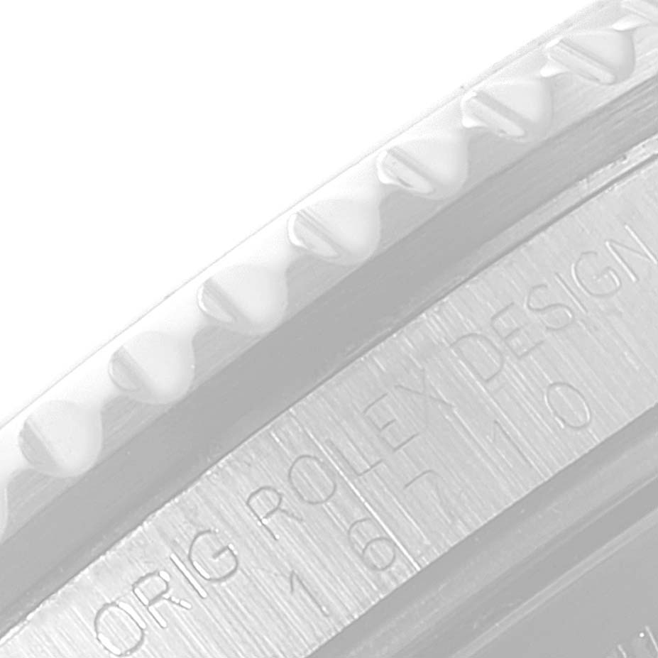 The image shows a close-up of the bezel and the engraved case side of a Rolex GMT-Master 16710 Men
s Stainless Steel Black Dial 16710 Men
s Stainless Steel Black Dial watch.