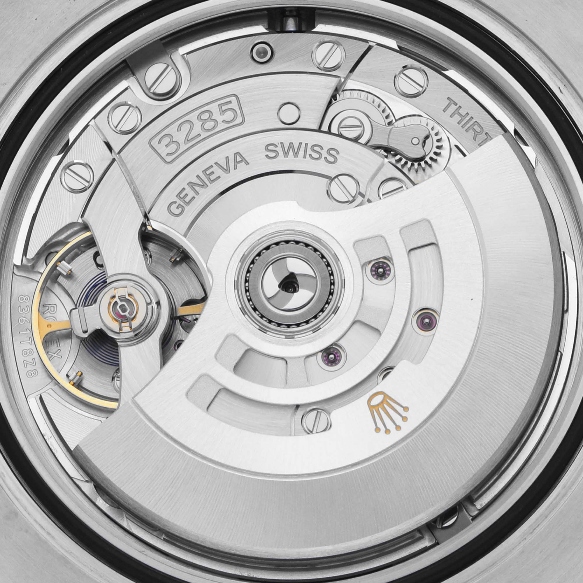 The image shows the movement of the Rolex GMT-Master 126711CHNR Men's Steel and Gold (two tone) Black Dial 126711CHNR Men's Steel and Gold (two tone) Black Dial, viewed from the back, highlighting the intricate mechanical parts.