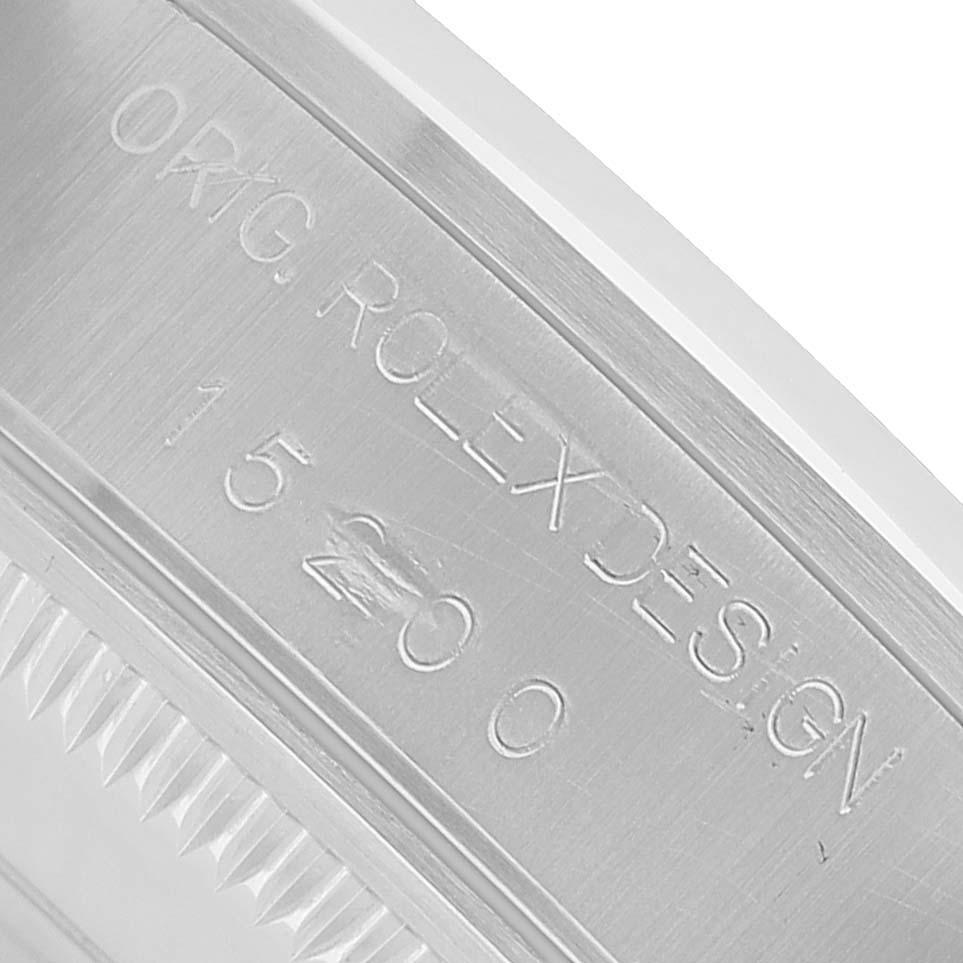 The image shows a close-up of the case side, engraved with "ORG. ROLEX DESIGN" and the model number for the Rolex Date 15200 Men's Stainless Steel Black Dial watch.