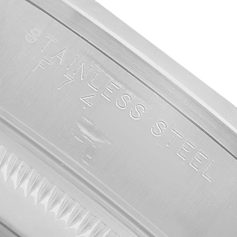 The image shows the side engraving of the Rolex Date 15200 Men's Stainless Steel Silver Dial model, highlighting "STAINLESS STEEL" on the bezel.