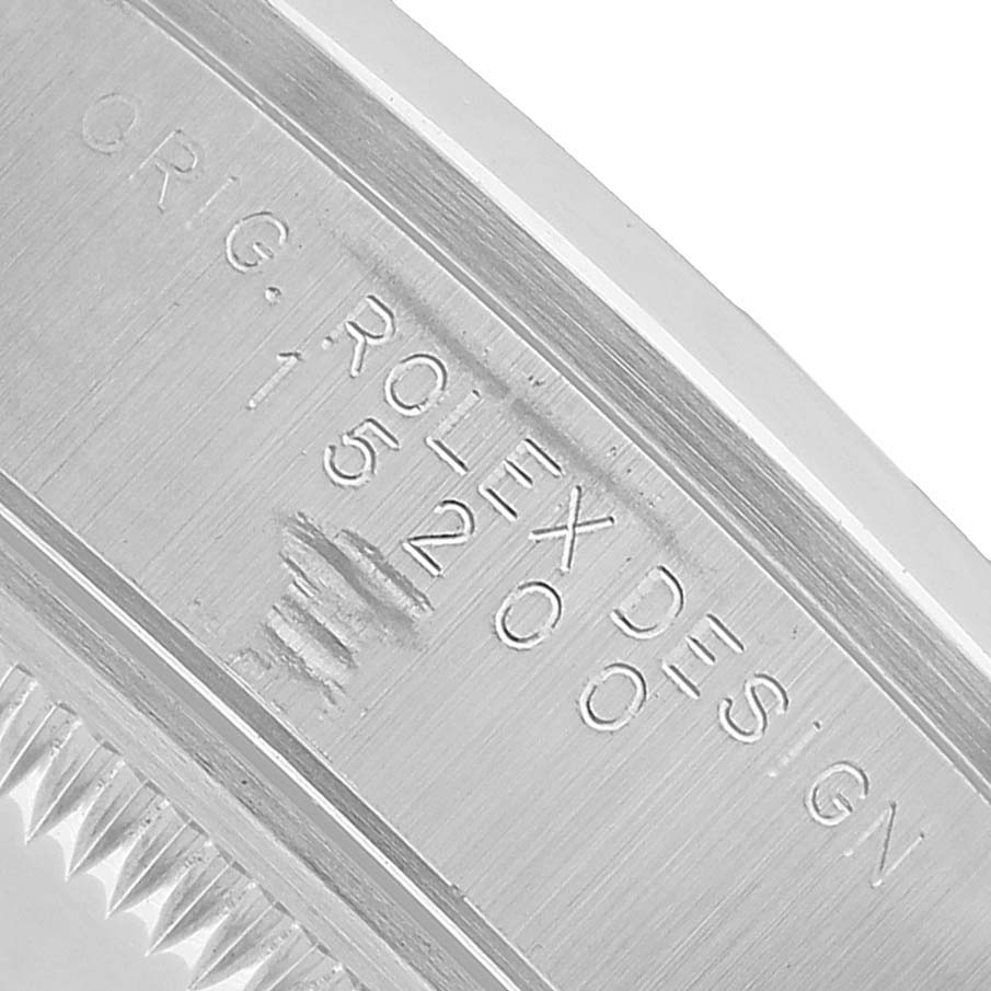 The image shows an angled close-up of the inner bezel of a Rolex Date 15200 Men's Stainless Steel Silver Dial model, displaying engraving details.