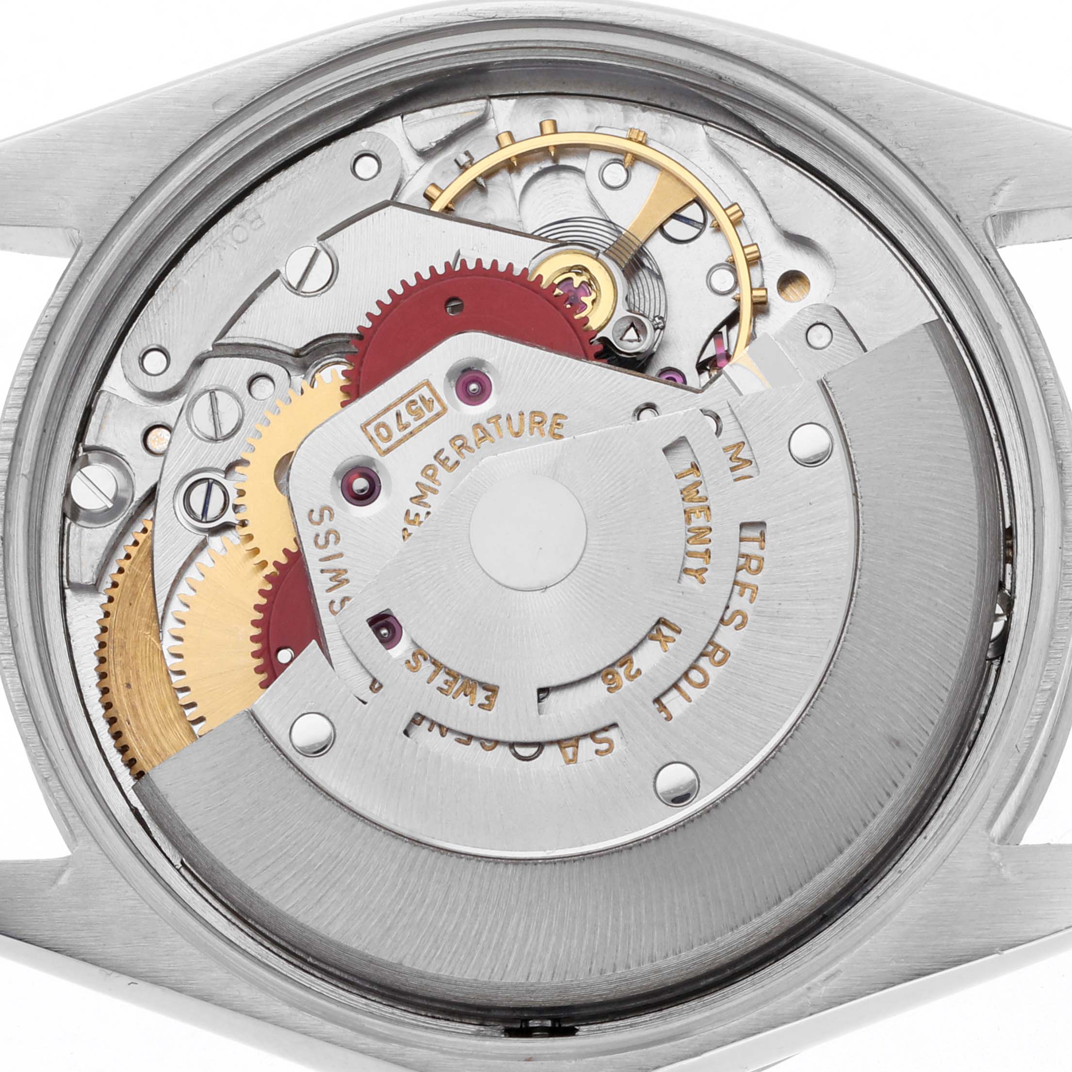 The image shows the movement of a Rolex Oyster Perpetual 1007 Men's Stainless Steel Silver Dial 1007 Men's Stainless Steel Silver Dial watch viewed from the back, highlighting gears and intricate mechanisms.