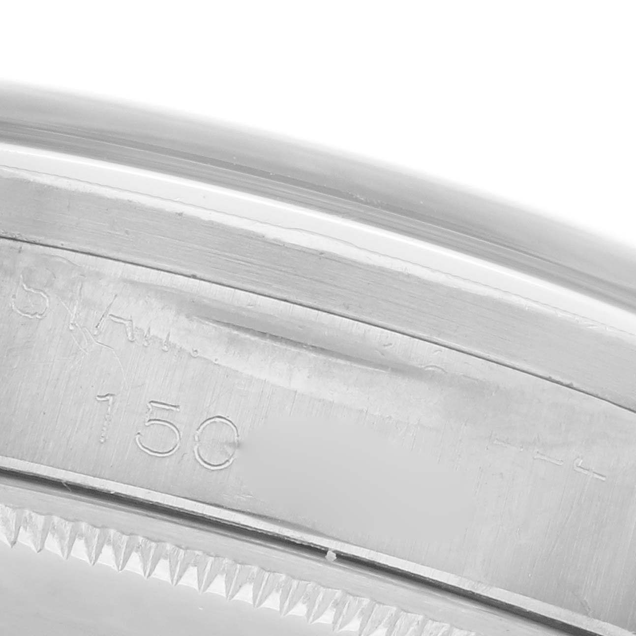 The image shows a close-up of the side of the Rolex Oyster Perpetual 1007 Men's Stainless Steel Silver Dial 1007 Men's Stainless Steel Silver Dial watch, focusing on the edge and engraved details.