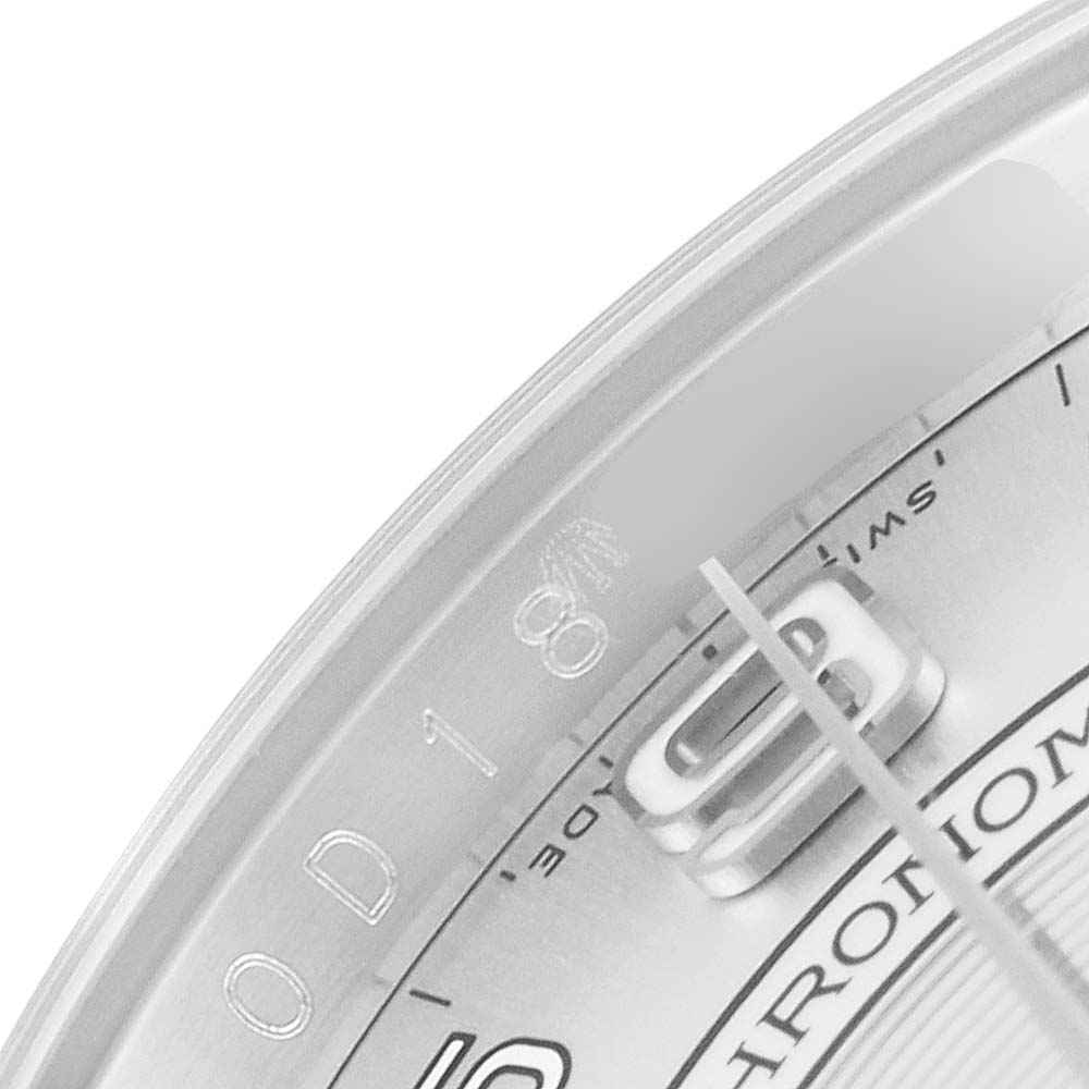This image shows a close-up of the dial and part of the bezel of a Rolex Oyster Perpetual 116000 Men's Stainless Steel Silver Dial 116000 Men's Stainless Steel Silver Dial watch, highlighting the ‘0D18’ engraving.