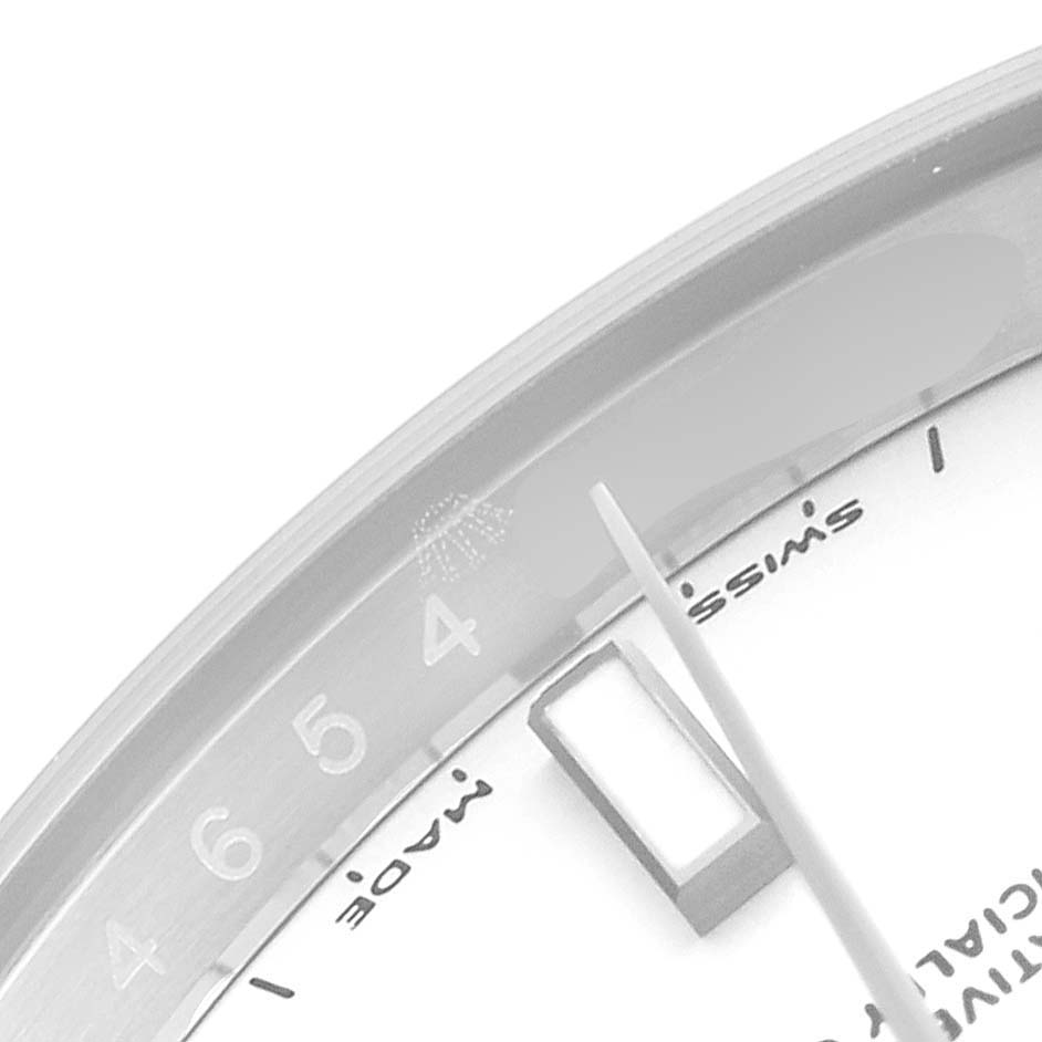 This image shows a close-up of the dial, chapter ring, and part of the bezel of a Rolex Oyster Perpetual 114200 Men's Stainless Steel White Dial 114200 Men's Stainless Steel White Dial watch.