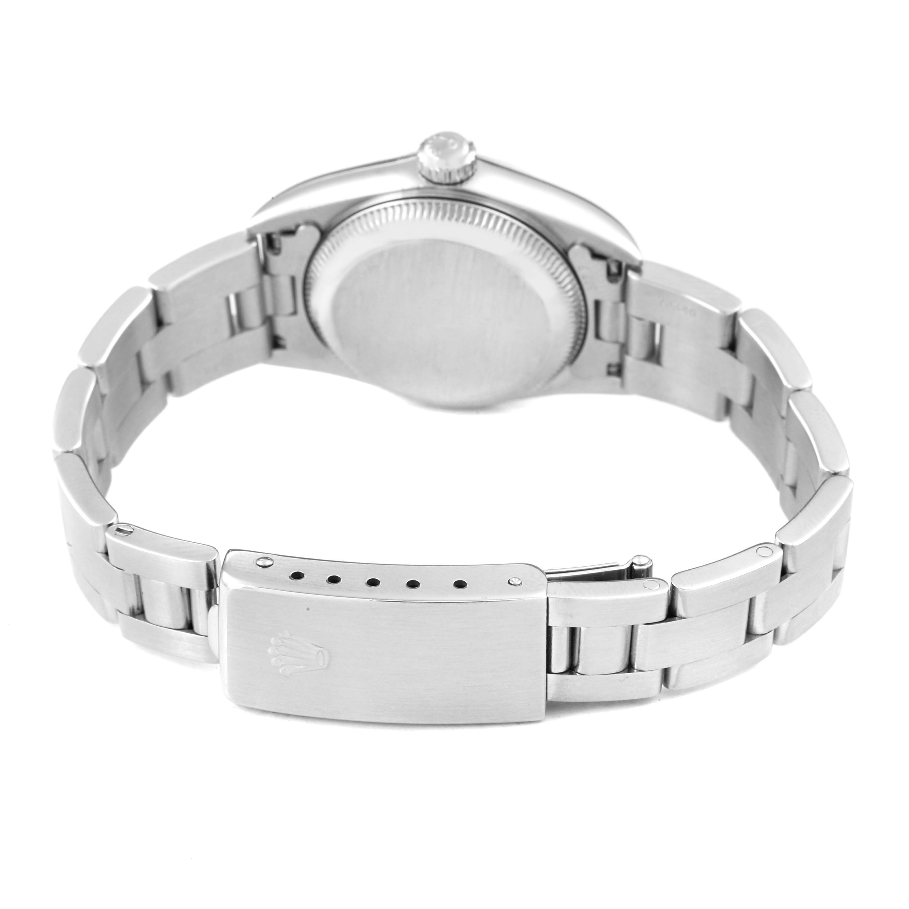 The image shows the back view of a Rolex Oyster Perpetual 76080 Women's Stainless Steel Black Dial watch, featuring the case back and bracelet clasp.