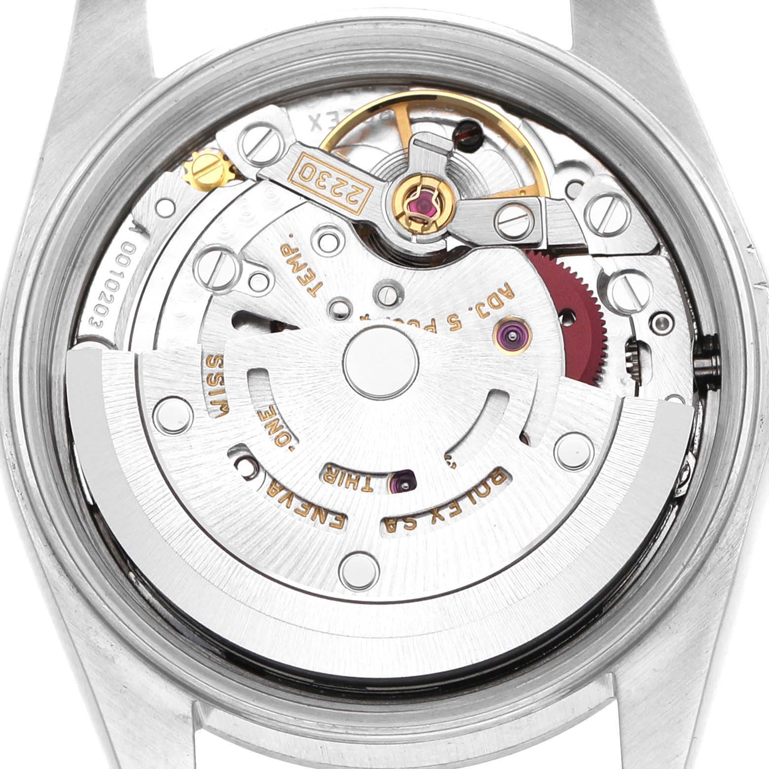 The image shows the movement of a Rolex Oyster Perpetual 76080 Women's Stainless Steel Black Dial watch, viewed from the back with visible gears and intricate details.