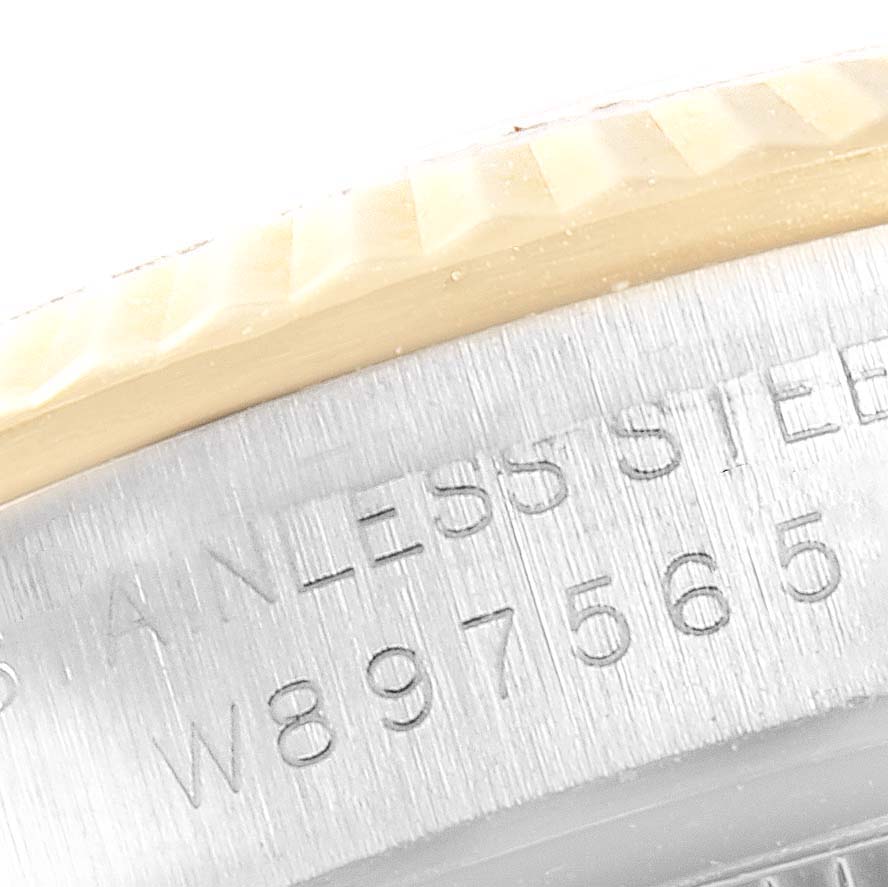 The image shows a close-up of the side of a Rolex Oyster Perpetual 67193 Women's Stainless Steel Champagne Dial 67193 Women's Stainless Steel Champagne Dial watch, highlighting its bezel and engraved stainless steel case.