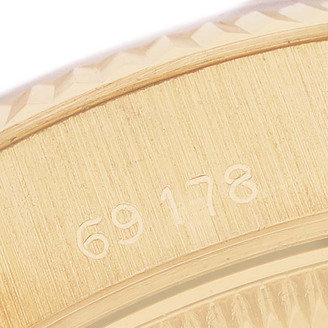The image shows the side of the bezel with a partial view of the textured edge, featuring engraved numbers on the Rolex President 69178 Women's Yellow Gold Champagne Dial model.