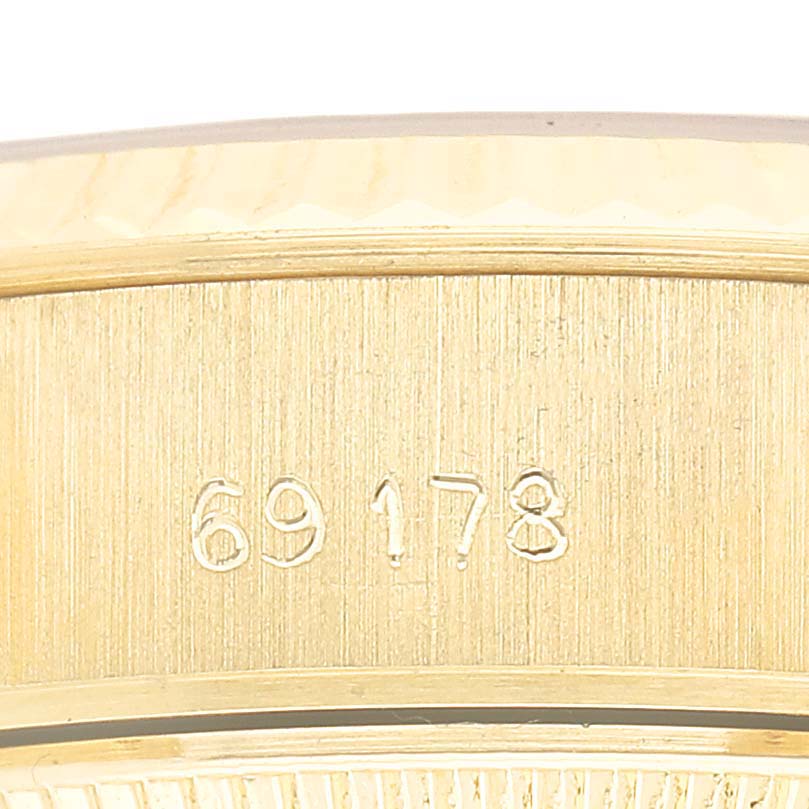 The image shows a close-up of the side of a Rolex President 69178 Men's Yellow Gold Champagne Dial model, featuring its engraved reference number.