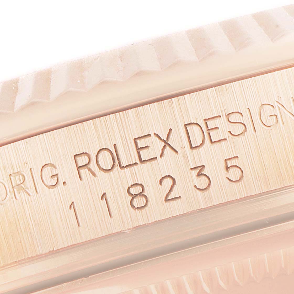 This close-up image shows the side engraving on the case of a Rolex President 118235 Men's Rose Gold Pink Dial 118235 Men's Rose Gold Pink Dial model watch.