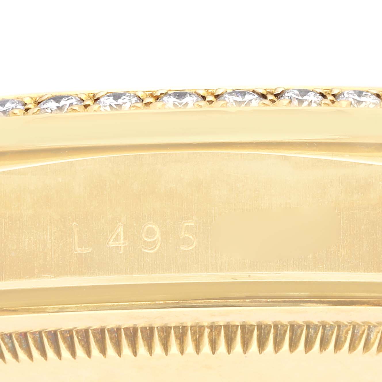 The image shows a close-up of the Rolex President 18348 Men's Yellow Gold Champagne Dial 18348 Men's Yellow Gold Champagne Dial watch's edge, highlighting the case with diamonds and a portion of the bezel.