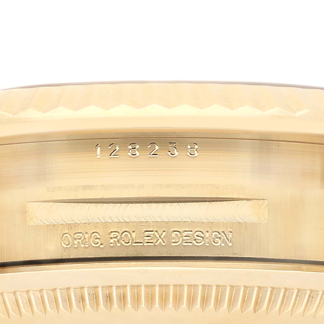 The image shows a close-up of the bezel and case side of a Rolex President 128238 Men's Yellow Gold Mother of Pearl Dial 128238 Men's Yellow Gold Mother of Pearl Dial model, displaying its serial numbers and design inscription.