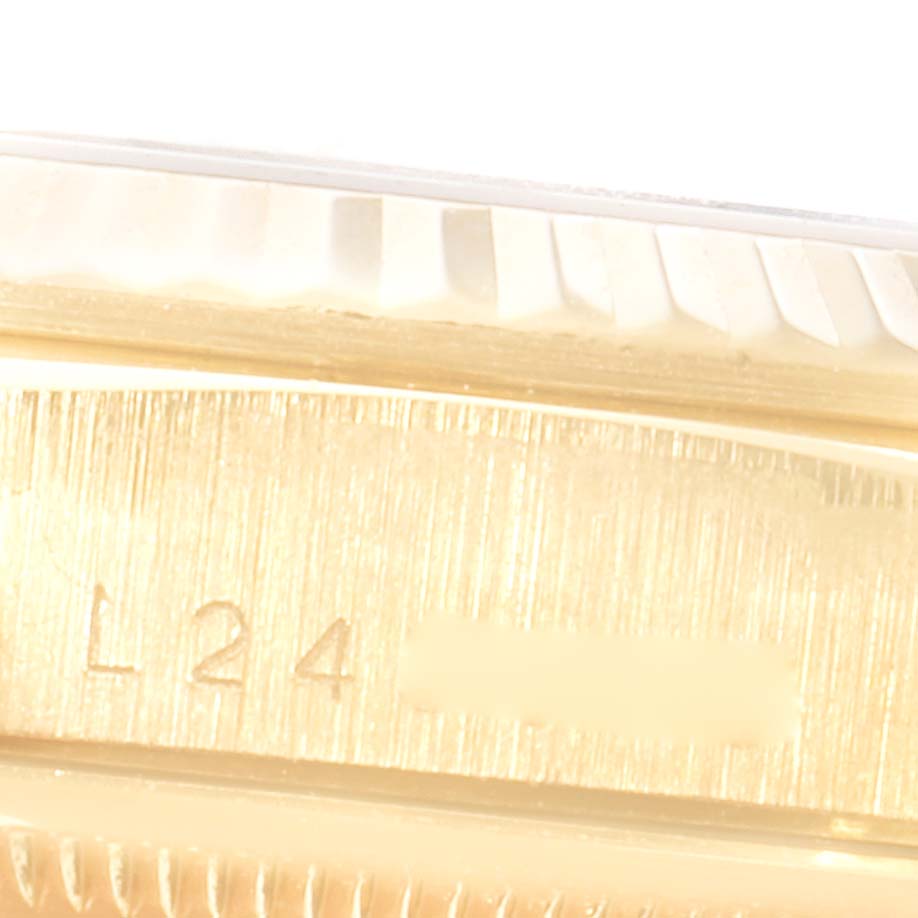 This close-up image shows the side of a Rolex President 18238 Men's Yellow Gold Blue Dial 18238 Men's Yellow Gold Blue Dial model watch, focusing on part of the case and serial number engraving.